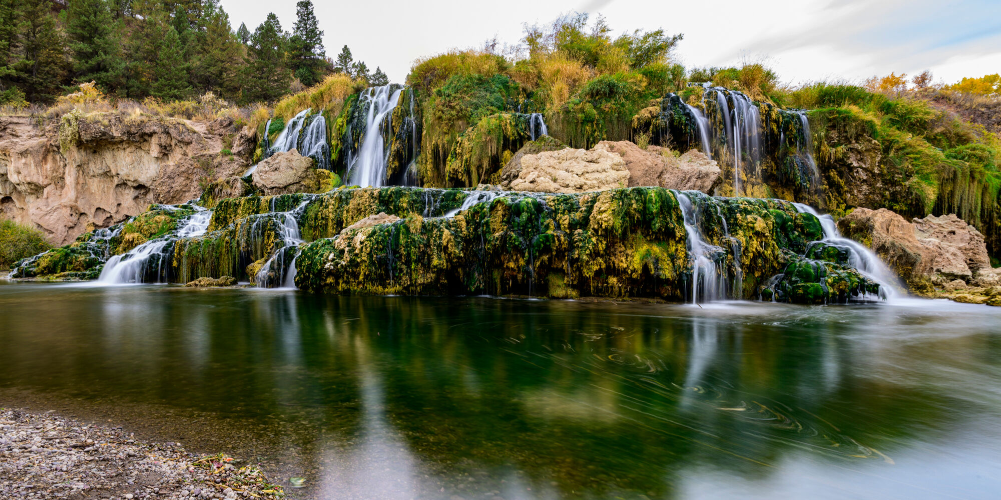 Fall Creek Falls is a stunning 60 foot waterfall that spill directly into the Snake River. The falls cascade ove a travertine...
